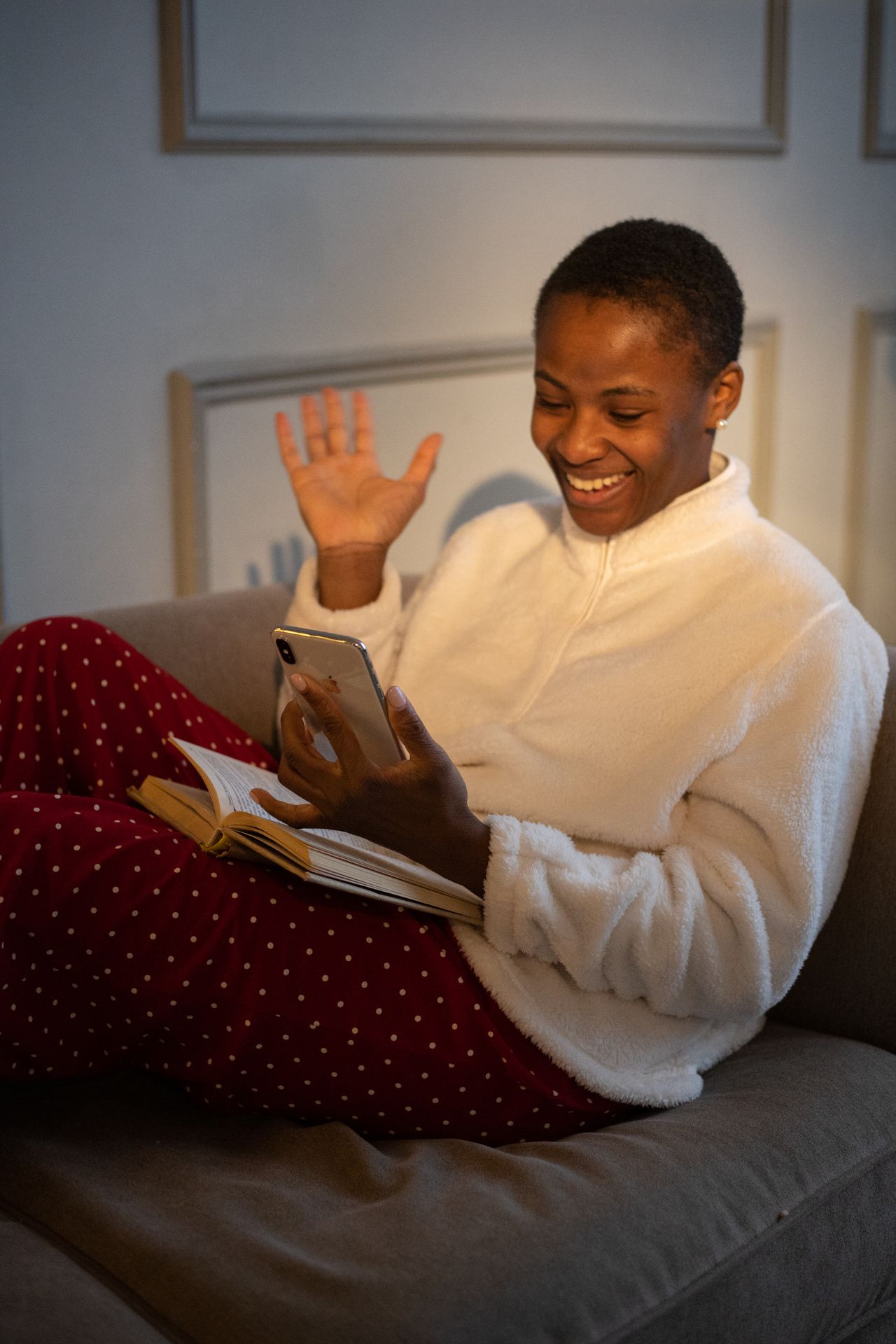 A learner relaxing at home with a book